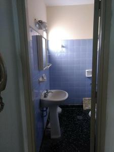 a bathroom with a sink and a toilet and a mirror at Departamento 6 personas con vista al mar in Mar de Ajó +8 photos