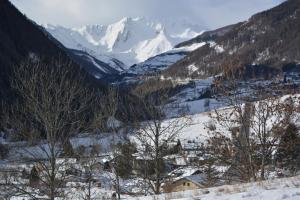 un valle cubierto de nieve con montañas en el fondo en Rue de Vachery 46, en Etroubles