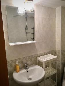 a bathroom with a sink and a mirror at El MATE apartment Sea Garden and Beach Free Parking in Varna City