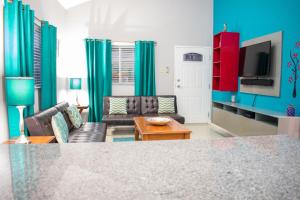 a living room with a couch and a table at Casa Victoria Golf Retreat in Caymanas