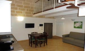 a living room with a table and a couch at La Ginestra Affittacamere in Ginosa