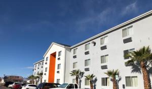 a white building with palm trees in front of it at Siegel Select Las Vegas Boulevard in Las Vegas