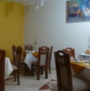 a dining room with chairs and a table and a table and chairsktop at Hotel Inkayra in Cusco