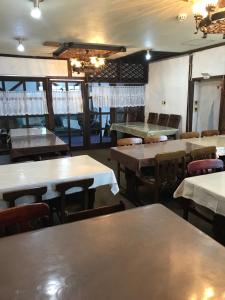 an empty dining room with tables and chairs at Aigakusou in Nozawa Onsen
