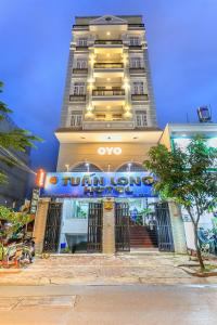 a hotel building with a sign in front of it at Tuan Long Hotel in Ho Chi Minh City