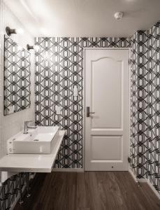 a bathroom with a white sink and a door at STARRY Residence Suite Hakuba Happo-one in Hakuba +61 photos