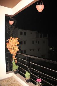 a balcony with two potted plants and two lights at Arra Transit Bengaluru International Airport Hotel in Yelahanka