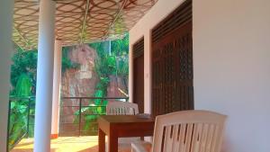 a dining room with a table and chairs and a large window at Mountain Heaven inn in Mirissa