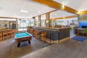 a pool table in a restaurant with a bar at Days Inn by Wyndham Lanham Washington DC in Lanham