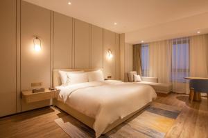 Voodi või voodid majutusasutuse Nanan Ao Sheng Yi Hao Hotel toas