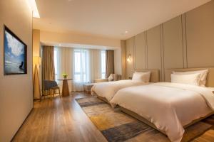 Voodi või voodid majutusasutuse Nanan Ao Sheng Yi Hao Hotel toas