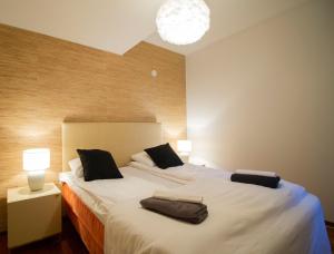 a bedroom with a large bed with two pillows at 2ndhomes Luxury Kamppi Center Apartment with Sauna in Helsinki