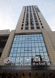 ein hohes Gebäude mit einem Schild an der Vorderseite in der Unterkunft Atour Hotel Hangzhou Xixi Zijingang in Hangzhou
