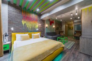 a bedroom with a large bed and a brick wall at Boutique Hotel Zelenyy Teatr in Simferopol