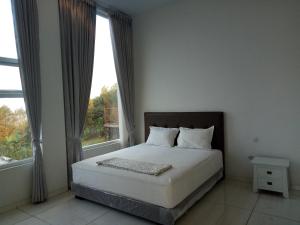 a bedroom with a bed and a large window at Villa batu malang panderman hill in Batu