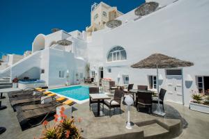 a villa with a swimming pool and a patio at Nomikos Villas in Fira