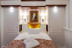 a bedroom with a bed with a yellow headboard at Europa Hotel Kühlungsborn in Kühlungsborn