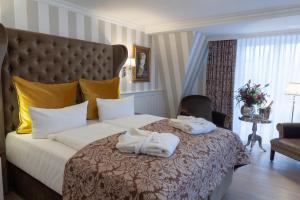 a hotel room with two towels on a bed at Europa Hotel Kühlungsborn in Kühlungsborn