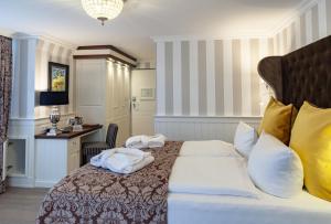 a hotel room with a bed with towels on it at Europa Hotel Kühlungsborn in Kühlungsborn