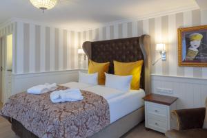 a bedroom with a bed with towels on it at Europa Hotel Kühlungsborn in Kühlungsborn