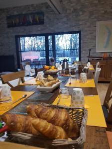 a table with bread and other food on it at Au Bois Flotté in Hourtin