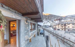 a balcony of a building with a view of a city at L'Atelier du Temps - BODON APPARTEMENT in Cogne +7 photos