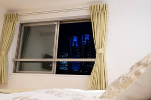 Postel nebo postele na pokoji v ubytování Studio Inn Nishi Shinjuku