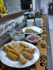 a buffet with plates of food on a table at Puri Ratna Joewita in Batusangkar