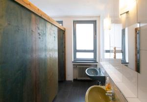 a bathroom with two sinks and a window at Hostel Aachen in Aachen