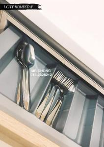 a drawer with some utensils in a cabinet at I-City Shah Alam @Home 1 in Shah Alam