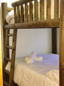 a wooden bunk bed with towels on the bottom bunk at Maribel Arttyco in Sierra Nevada