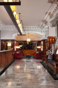 a lobby with red couches and a staircase at The Mosser Hotel in San Francisco