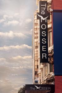 a street sign in front of a large building at The Mosser Hotel in San Francisco