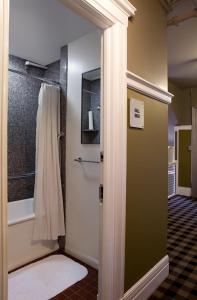 a bathroom with a shower and a door with a towel at The Mosser Hotel in San Francisco