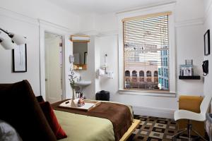 a bedroom with a bed and a window at The Mosser Hotel in San Francisco