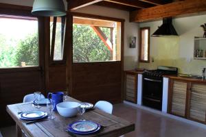 a kitchen with a wooden table with plates and glasses on it at Casa El Drago in La Cumbre