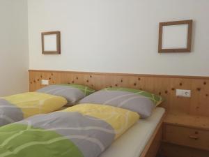 three beds with pillows on them in a bedroom at Haus am See in Ried im Oberinntal