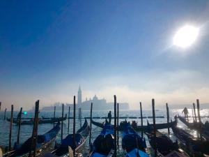 a group of boats are lined up in the water at Ca Lena in Venice