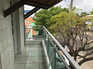 a balcony of a house with a view of the beach at Toca do guaxinim in Itarema