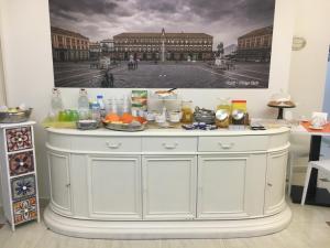 a large white cabinet with food on top of it at Donna Vicenza Bed & Breakfast in Naples