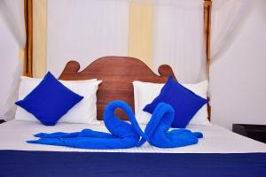 Letto o letti in una camera di Ocean Gate Villa Tangalle
