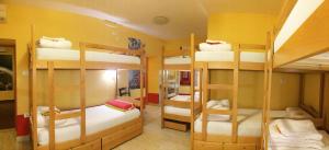 a room with three bunk beds in it at Europa Hostel Portorož in Portorož