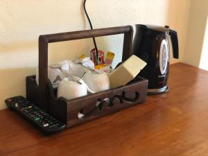 a black candle holder sitting on a table with a coffee mug at Phi Phi Villa Resort-SHA Extra Plus in Phi Phi Islands