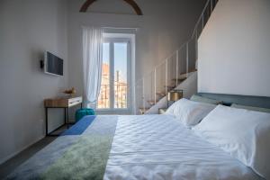 a bedroom with a large bed and a staircase at Relais Luce Florence in Florence