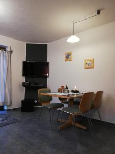 a dining room with a table and chairs at Haus Schnurbus in Olsberg