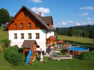 a large house with a playground and a pool at U Sadílků in Paseky nad Jizerou