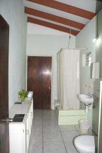 a bathroom with a sink and a toilet and a shower at Somewhere Special Guesthouse in Gros Islet