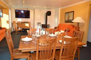 a dining room with a wooden table and chairs at Luxurious Trailside Village One Bedroom Condo #1 in Killington +11 photos