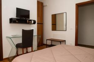 a bedroom with a bed and a table and a mirror at Happy Rooms in Easy House 2 in Naples