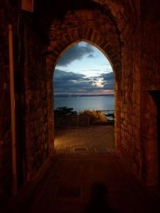 an archway in a building with a view of the ocean at Borgo San Savino in San Savino